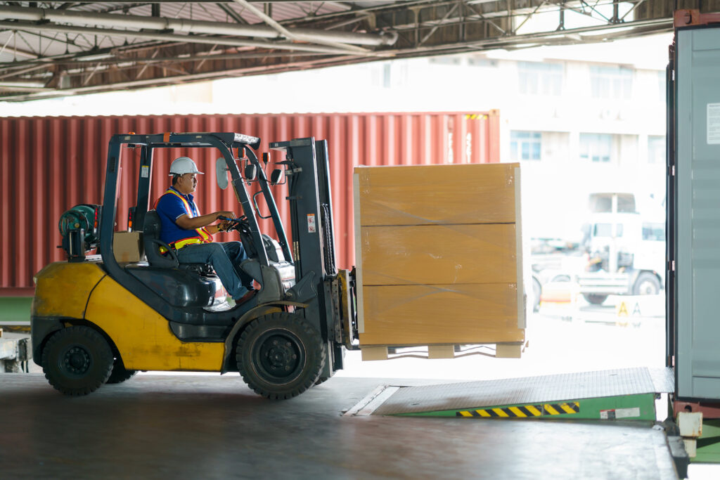 Forklift loading into cargo containers